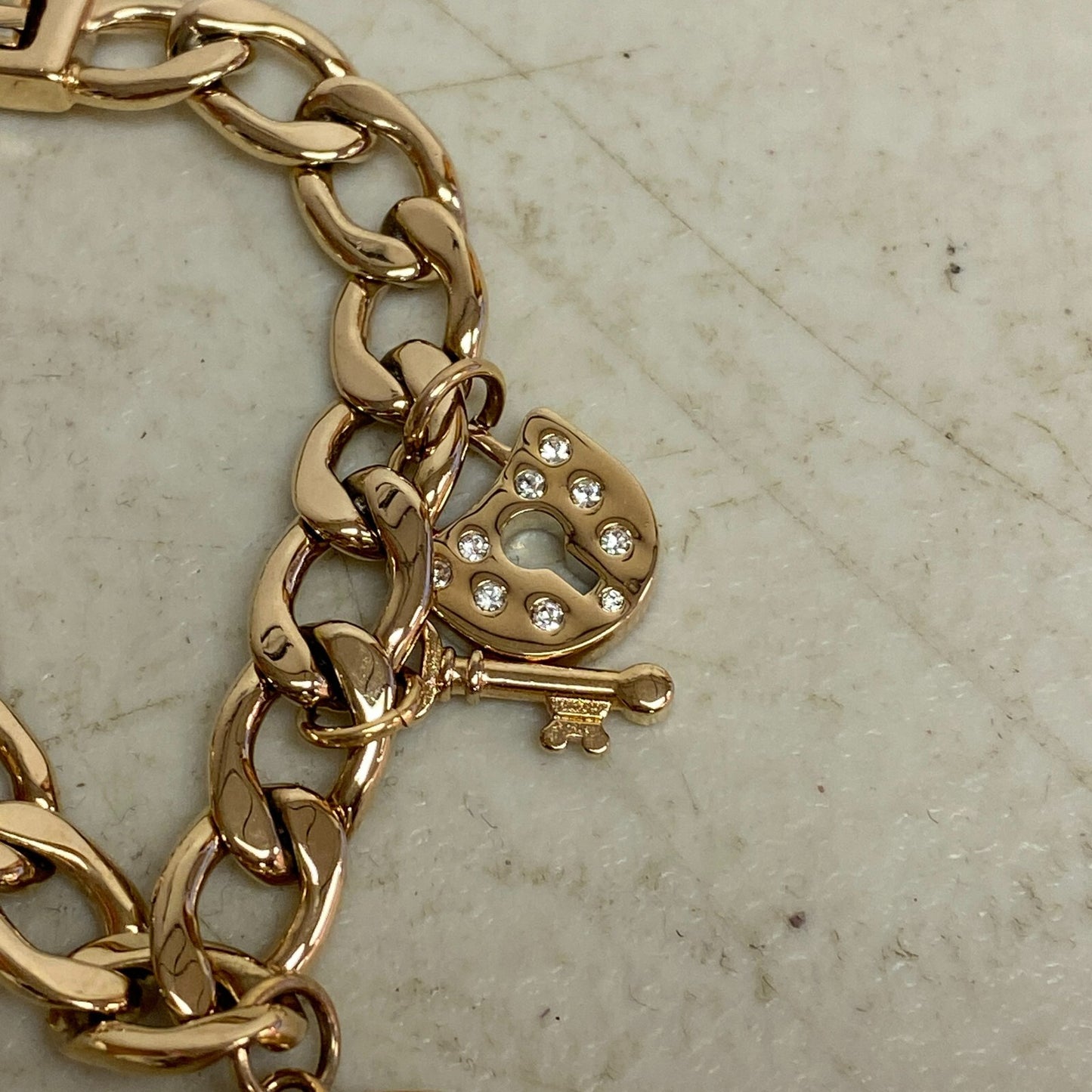 Armitron Women link bracelet with charm watch with key and lock charms 75/5067RG